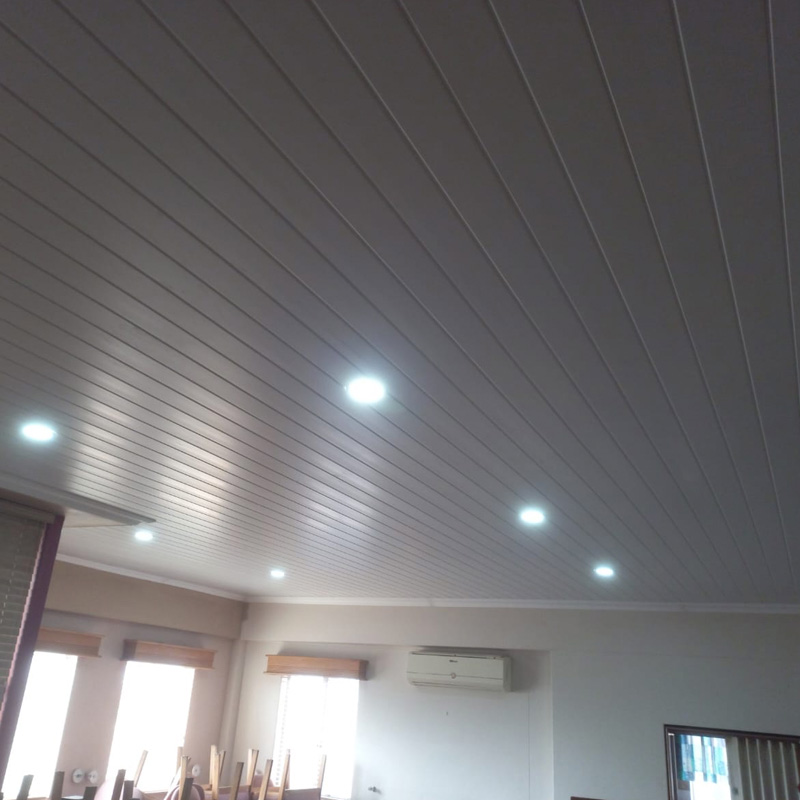 Freshly installed white PVC ceiling with recessed lighting