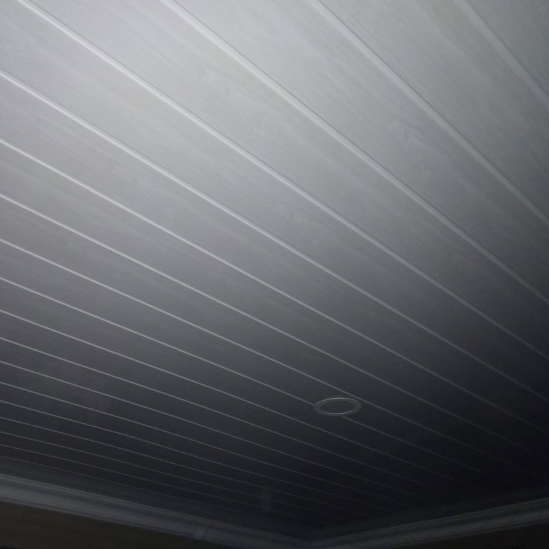 Freshly installed white PVC ceiling with recessed lighting