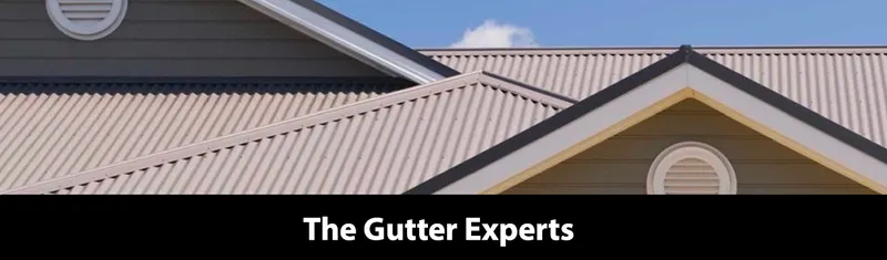 Seamless aluminium gutter and downpipe installed along a corrugated roofline